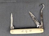 Vintage folding pocket knife with double blades, and a button hook. The knife is in very good