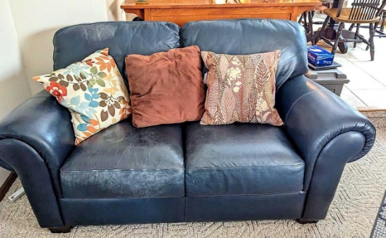 Natuzzi blue green leather love seat approx 5' long, 3' deep from very back. Some wearing on the