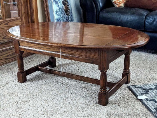 44" x 28" oval wood coffee table in great condition and comes with an extra top (not pictured).