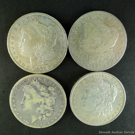 1880-O, 1881, 1887-O and 1884-O Morgan silver dollars.
