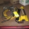 EXT. CORD TROUBLE LIGHTS, LAWN SPRINGLER, GREASE GUN