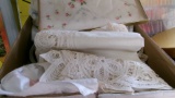 2-BOXES OF LINENS, NAPKINS, APRONS, TABLE CLOTHES, CROSS STITCH & THREAD