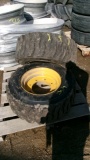 12 X 16.5. SKID LOADER TIRES ON 8 BOLT RIMS