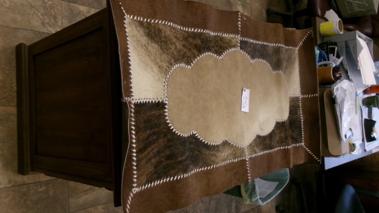 26" X 49" COWHIDE RUG, BEAR SKULL, 11 BEAR CLAWS, & A SHARK TOOTH