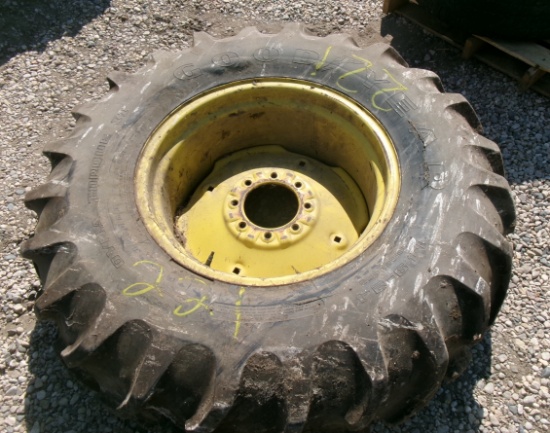 14.9 X 24" TIRE on 8 bolt rim ( tire has damage but holds air )