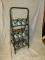 Oil can rack w/ 15 Quaker State oil cans, 17