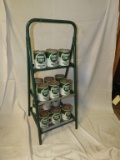 Oil can rack w/ 15 Quaker State oil cans, 17