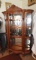 Oak curved glass china cabinet w/ lion accent