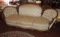 Upholstered couch w/ carved wood accents, 37