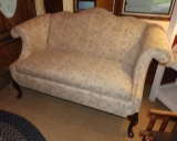 Upholstered love seat w/ exposed wood legs