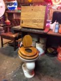 Old oak toilet w/ old oak lid w/ childs seat above