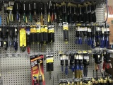 ASSORTED SCREW DRIVERS (HANGING ON RACK & UNDER)