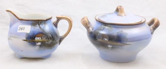 Mrkd. Noritake creamer and cov. sugar set, Cottage by lake/white swan on water on blue shading -