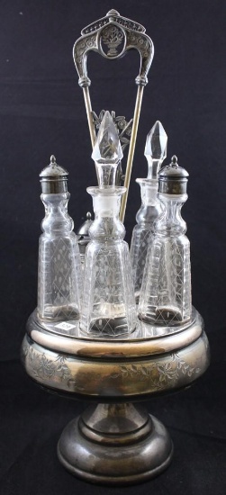 Rockford Silverplate castor set with 5 matching bottles, holder has floral decorated rim and