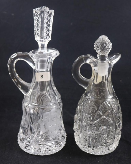 (2) Clear cruets: 1-8.5"h EAPG with Intaglio flower; 1-7"h EAPG, Imperial paper label