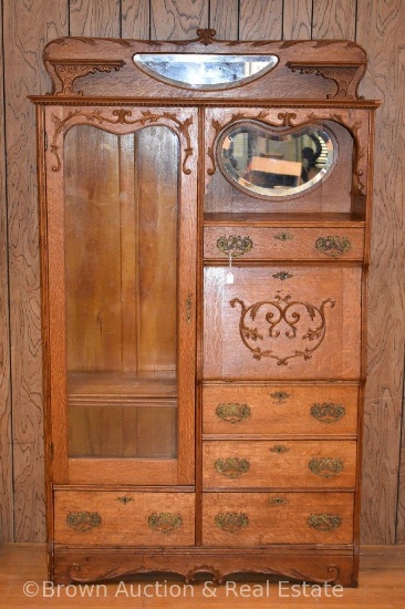 Oak secretary/bookcase combo with hooded drop-front lid desk, other drawers for storage, carved