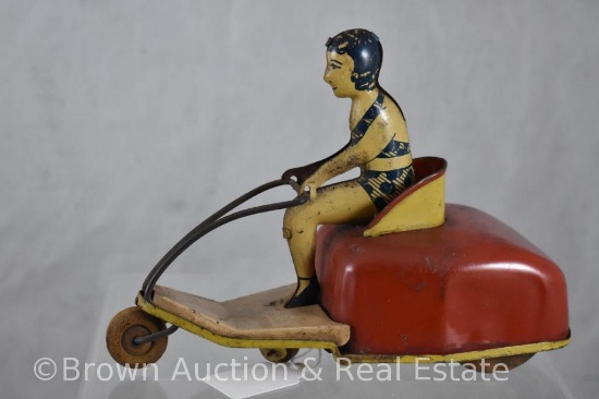 Tin wind-up toy - girl in 2 pc. swimsuit driving 3-wheel cart - wants to work
