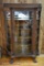 Curved glass china cabinet with large paw feet
