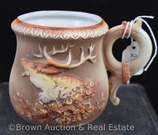 Porcelain mug with carved elk