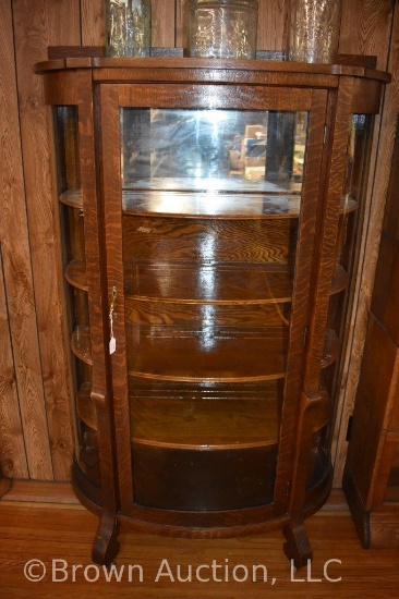 Antique curved glass china cabinet, mirror-backed top shelf