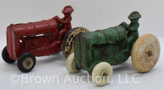 Pair of small Arcade cast iron tractors with drivers