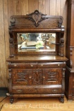 Large hooded sideboard w/beveled mirrored back, ornate applied carved decorations with Griffin heads