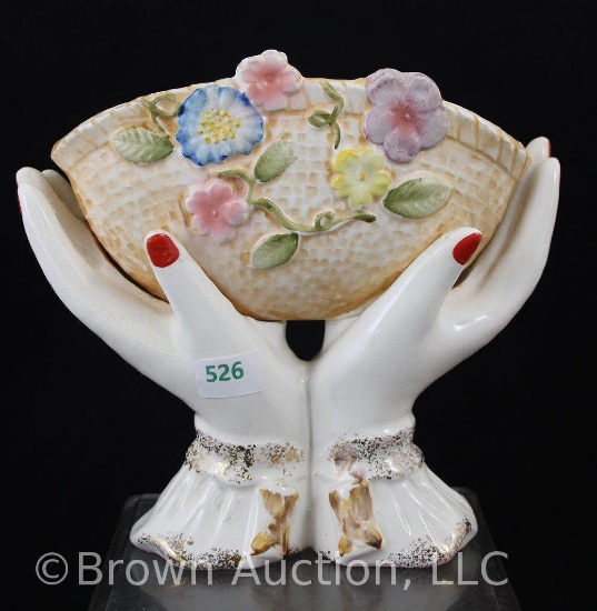Porcelain hands holding floral decorated planter