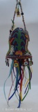 Colorful beaded Native American bell featuring animal designs