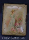 Victorian celluloid photo album, woman picking flower scenic cover