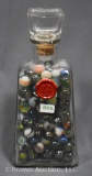 Clear glass jar full of assrted marbles