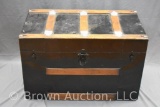 Large black metal flat top steamer trunk, leather handles intact