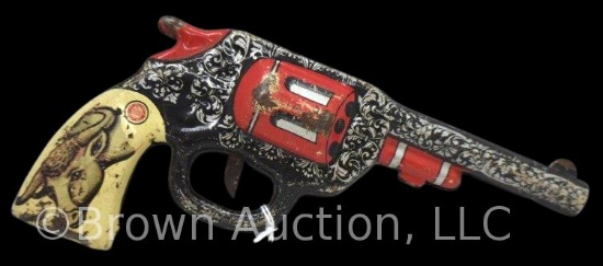 Ohio Art Company Tin Litho clicker gun; brightly colored with a horned bull on both sides of the