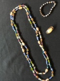 Womens necklace, a bracelet and a pin, costume jewelry