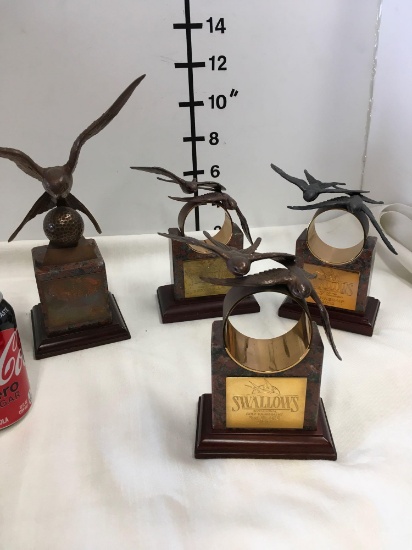 Marble stands, brass/metal birds trophy's. Have placard of "Swallows Invitational Golf Tournament"