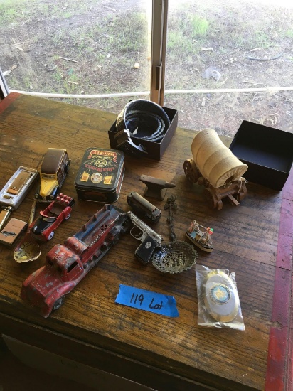 Assorted items. Belt buckle, belt, wagon, lighters, etc