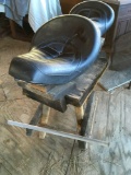 Motorcycle seat on wood stand. (Gazebo area)