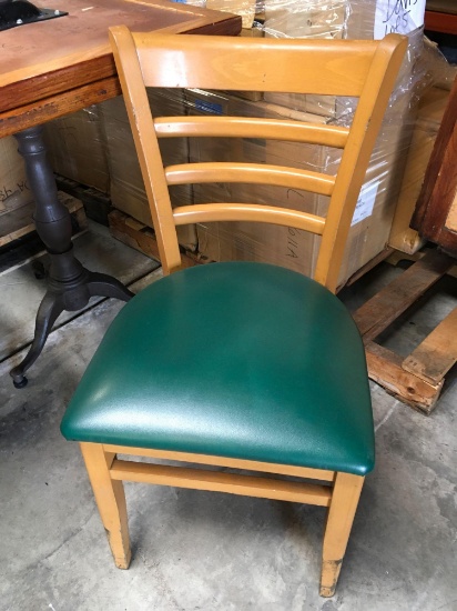 Dining chairs with green padded seats