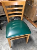 Dining chairs with green padded seats