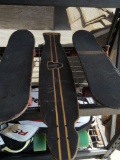 3) skate boards. Middle one missing one wheel