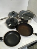 Lot. 2) Green pans 1) Amazon basics pots 1) Farberware 1) Amazon basics pans