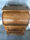 Vintage three drawer roll top wood desk. Approximately 42