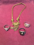 4 pieces. Costume jewelry. Necklace & 3 rings. Size woman?s 8,'2) men's 10