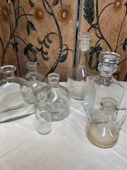 Lot of assorted glass containers / decanters. 7 pieces