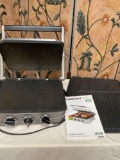 Cuisinart griddle with 2 removable poking plates and manual. Turned on