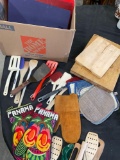 Lot of assorted kitchen ware. Spoons, cutting boards , mittens, spatulas, etc.