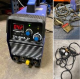 TIG-200 welder with assorted accessories. Turned on