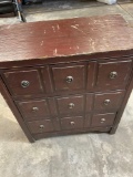Three drawer wood dresser with metal accents. 32