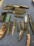 Assorted knives, foldable knives , sheaths, ammo box. 14 pieces