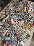 Thousands of baseball , hockey, football, etc cards. Some. are stuck together, folded, etc