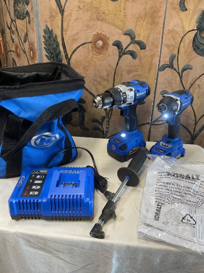 Kobalt Brushless impact drivers, charger station, two batteries, holder, bag. Turned on WORKS